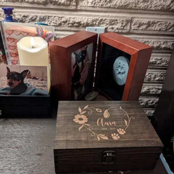 Dark rustic wooden keepsake box with floral engraving and memorial dates.